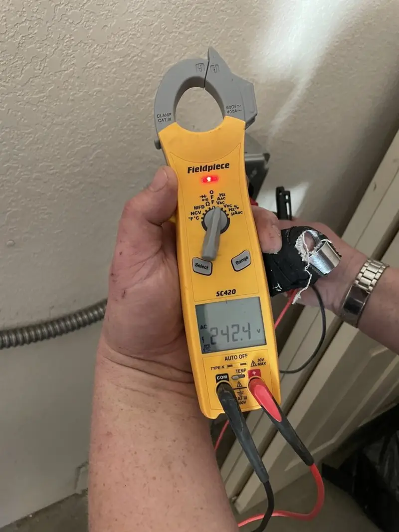 Voltage testing with clamp meter during Ceiling Fan Installation in Pike Creek Valley